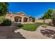 Attractive backyard features a covered patio, green lawn, and desert landscaping at 2226 N Gentry --, Mesa, AZ 85213