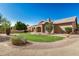 A large backyard with grass, gravel, desert landscaping and covered patio at 2226 N Gentry --, Mesa, AZ 85213
