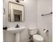 Powder room featuring a pedestal sink, toilet, and vanity mirror at 2226 N Gentry --, Mesa, AZ 85213