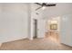 A spacious bedroom with neutral carpet features a ceiling fan and a doorway to the next room at 2226 N Gentry --, Mesa, AZ 85213