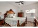 Cozy bedroom is furnished with a dresser, bedside table and bed featuring a decorative wood frame at 2226 N Gentry --, Mesa, AZ 85213