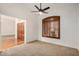 A simple bedroom with neutral carpet, shutters on a window and double doors to the hallway at 2226 N Gentry --, Mesa, AZ 85213