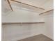 A bright walk-in closet space with white walls, wood floors and ample shelving units to maximize storage at 2226 N Gentry --, Mesa, AZ 85213