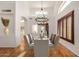 Bright dining room features hardwood floors, stylish chandelier, shuttered windows and high ceilings at 2226 N Gentry --, Mesa, AZ 85213