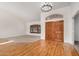 Inviting entryway featuring hardwood floors, double doors, chandelier, and plantation shutters at 2226 N Gentry --, Mesa, AZ 85213