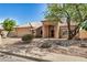 Charming single-story home showcasing desert landscaping, an attached garage, and a tile roof at 2226 N Gentry --, Mesa, AZ 85213