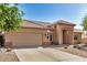 Single-story home featuring a spacious driveway, attached garage, clay tile roof, and desert landscaping at 2226 N Gentry --, Mesa, AZ 85213