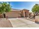 Attractive single-story home displaying a large driveway, desert landscaping, an attached garage, and a clay tile roof at 2226 N Gentry --, Mesa, AZ 85213