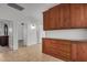 Hallway with tiled floors that has wood storage and multiple doorways at 2226 N Gentry --, Mesa, AZ 85213