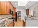 Kitchen with granite counters, wood cabinets, and stainless appliances at 2226 N Gentry --, Mesa, AZ 85213