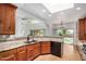 Open kitchen featuring granite counters, wood cabinets, and view to backyard at 2226 N Gentry --, Mesa, AZ 85213