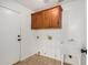 Well-lit laundry room with tile flooring, sink, cabinets and access to the exterior at 2226 N Gentry --, Mesa, AZ 85213