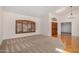 Bright living room showcasing hardwood and carpet flooring, plantation shutters, and ample natural light at 2226 N Gentry --, Mesa, AZ 85213