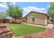 Landscaped backyard featuring a green lawn, with a patio and views of the home's exterior at 23787 W Yavapai St, Buckeye, AZ 85326