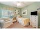 A cozy bedroom with a twin bed, comfortable armchair, and plenty of space at 23787 W Yavapai St, Buckeye, AZ 85326