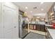 This is the kitchen with stainless steel refrigerator and updated countertops at 23787 W Yavapai St, Buckeye, AZ 85326