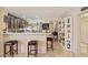 Modern kitchen bar top seating area, seamlessly connected to the dining space for easy entertaining at 23787 W Yavapai St, Buckeye, AZ 85326