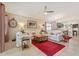 Spacious living room with neutral walls, tile flooring, a ceiling fan, and an open layout at 23787 W Yavapai St, Buckeye, AZ 85326