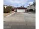 Charming single-story home with a spacious driveway and solar panels on the roof at 2533 N 88Th Ln, Phoenix, AZ 85037