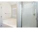 Bathroom features a white tiled shower, soaking tub, and small window at 2698 E Denim Trl, San Tan Valley, AZ 85143