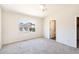 Bright bedroom with vaulted ceiling features neutral walls, ceiling fan, and large window at 2698 E Denim Trl, San Tan Valley, AZ 85143