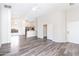 Open living room features gray wood floors, vaulted ceiling, and access to kitchen at 2698 E Denim Trl, San Tan Valley, AZ 85143