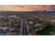 Scenic aerial view of the community featuring lush landscaping, a pool, and sport courts at 3055 N Red Mtn # 77, Mesa, AZ 85207