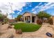 Beautiful backyard featuring a pool, lush green lawn, and a covered patio area at 3055 N Red Mtn # 77, Mesa, AZ 85207
