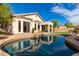 Gorgeous backyard showcasing a pristine pool, covered patio, and views of the home's exterior at 3055 N Red Mtn # 77, Mesa, AZ 85207