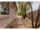 Backyard walkway with stone steps, mature trees, and a view of the pool, enhancing outdoor tranquility at 3055 N Red Mtn # 77, Mesa, AZ 85207