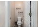 Powder room with a toilet, white walls, a neutral floor, and a wire basket for supplies at 3055 N Red Mtn # 77, Mesa, AZ 85207