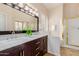 Bathroom with dual sinks, dark wood cabinets, marble counters, a shower, and a garden window at 3055 N Red Mtn # 77, Mesa, AZ 85207