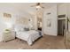 Cozy bedroom with neutral walls, carpet floors, ceiling fan, and ensuite bathroom entrance at 3055 N Red Mtn # 77, Mesa, AZ 85207