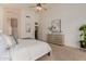 Inviting bedroom with a ceiling fan, dresser, and entry to the bathroom at 3055 N Red Mtn # 77, Mesa, AZ 85207