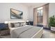 Cozy bedroom showcasing stylish décor, a comfortable bed, and natural light from the window at 3055 N Red Mtn # 77, Mesa, AZ 85207