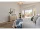 Bright bedroom featuring a ceiling fan, a dresser with modern art, and sliding glass doors to a patio at 3055 N Red Mtn # 77, Mesa, AZ 85207