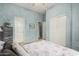 Stylish bedroom featuring decoratively painted blue walls, and access to closet and ensuite bathroom at 3055 N Red Mtn # 77, Mesa, AZ 85207