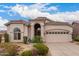 Exterior elevation of a stucco home with a tile roof, arched entry, and desert landscaping at 3055 N Red Mtn # 77, Mesa, AZ 85207