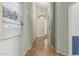 Neutral hallway showcasing tiled floors, art, natural light and leading to the front door at 3055 N Red Mtn # 77, Mesa, AZ 85207