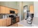 Well-equipped kitchen featuring wooden cabinets, stainless steel appliances, and ample counter space at 3055 N Red Mtn # 77, Mesa, AZ 85207