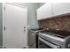 Convenient laundry room equipped with modern washer and dryer, cabinets and tiled backsplash at 3055 N Red Mtn # 77, Mesa, AZ 85207