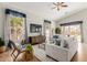 Open living room boasts neutral furniture, accent rug, ceiling fan and natural light from nearby windows at 3055 N Red Mtn # 77, Mesa, AZ 85207