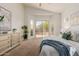 Inviting primary bedroom featuring a view of the pool, neutral decor, and cozy carpet at 3055 N Red Mtn # 77, Mesa, AZ 85207
