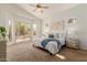 Serene primary bedroom with a ceiling fan, sliding glass door to the pool, and neutral decor at 3055 N Red Mtn # 77, Mesa, AZ 85207