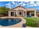 Stunning backyard pool with lush landscaping and a covered patio for outdoor relaxation at 3055 N Red Mtn # 77, Mesa, AZ 85207