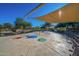 Community splash pad featuring colorful ground details, sun shades, and nearby bench seating at 3055 N Red Mtn # 77, Mesa, AZ 85207