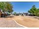 Large backyard with patio, mature trees, and privacy fence is ready to enjoy at 350 N 88Th St, Mesa, AZ 85207