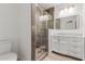 Bathroom with updated vanity, modern fixtures, and a glass-enclosed shower at 350 N 88Th St, Mesa, AZ 85207