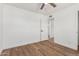 Bedroom with laminate flooring, ceiling fan, and white trim, adjacent to the doorway at 350 N 88Th St, Mesa, AZ 85207