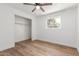 Bright bedroom with a ceiling fan, wood-look flooring and walk-in closet at 350 N 88Th St, Mesa, AZ 85207